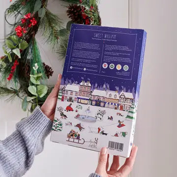 Back of the Pooch dog advent calendar held in hands, showing ingredients and feeding information